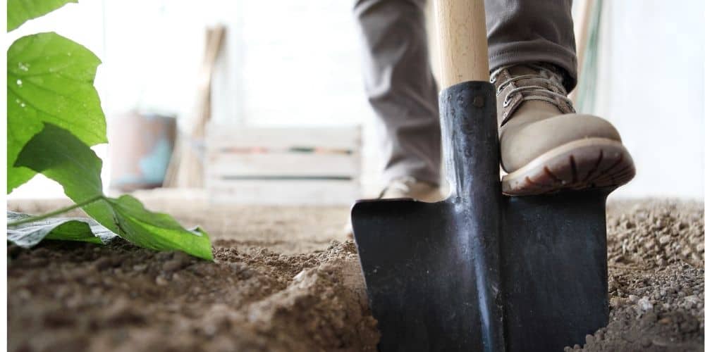 man using a digging shovel